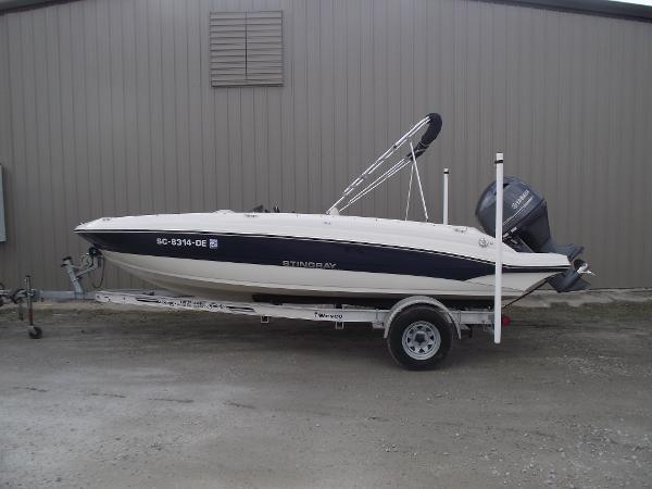 Stingray 182 SC 2016 Stingray 182 SC boat on trailer, parked outside a building.