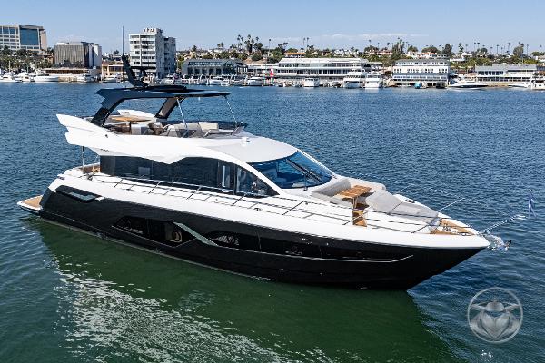 Sunseeker Manhattan 68 Luxurious 2025 Sunseeker Manhattan 68 yacht cruising in a scenic marina.