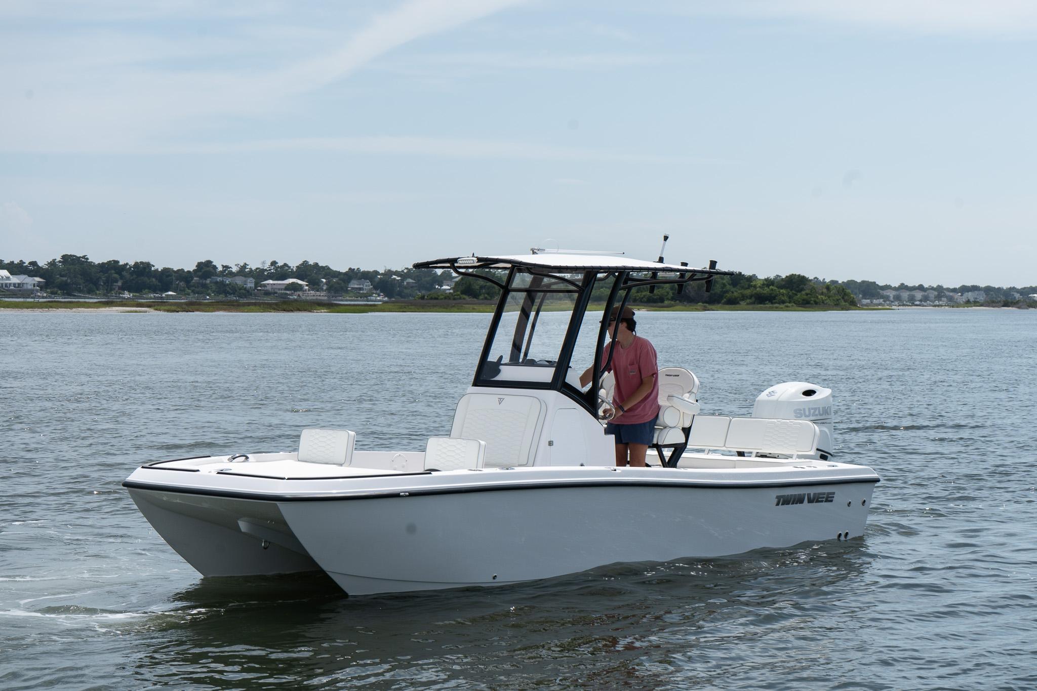 Twin Vee 22 Baycat 2026 Twin Vee 22 Baycat boat cruising on calm waters with a person onboard.