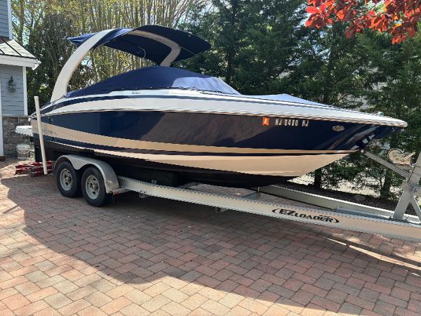 Regal 2500 Bowrider 2012 Regal 2500 Bowrider boat on trailer, parked on brick driveway.