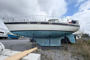 Hallberg-Rassy 42E 1983 Hallberg-Rassy 42E sailboat on land, blue hull, overcast sky.