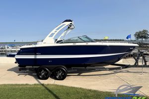 Chaparral 247 SSX 2025 Chaparral 247 SSX boat on trailer by lakeside dock.