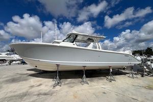 Pursuit S 358 Sport 2026 Pursuit S 358 Sport boat on stands under a blue sky.