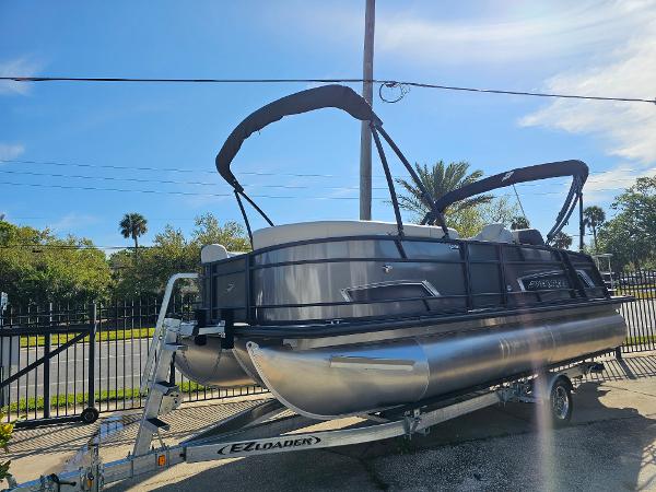 Starcraft EXS 1 Q DH 2025 Starcraft EXS 1 Q DH pontoon boat on trailer, sunny day, outdoor setting.