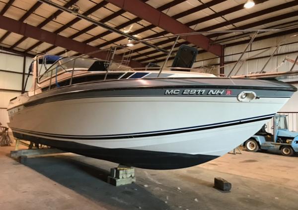 Formula 29 PC 1988 Formula 29 PC boat in storage, elevated on blocks, inside a warehouse.