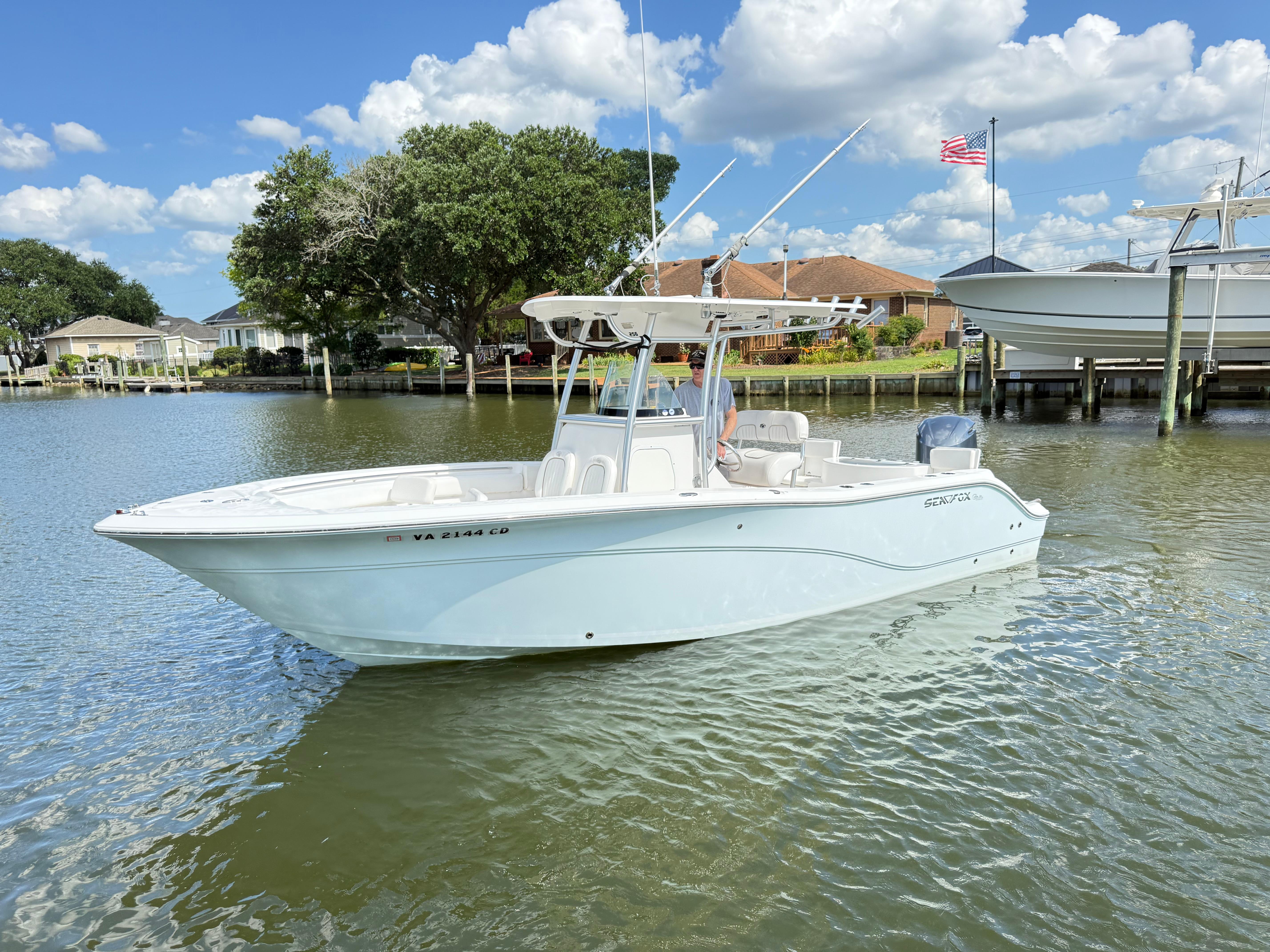 Sea Fox 256 Commander 2015 Sea Fox 256 Commander boat on calm water, clear sky, American flag in background.