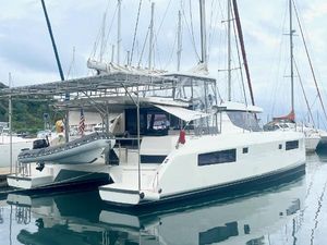 Leopard 45 2018 Leopard 45 catamaran docked in a marina, featuring sleek design and modern amenities.