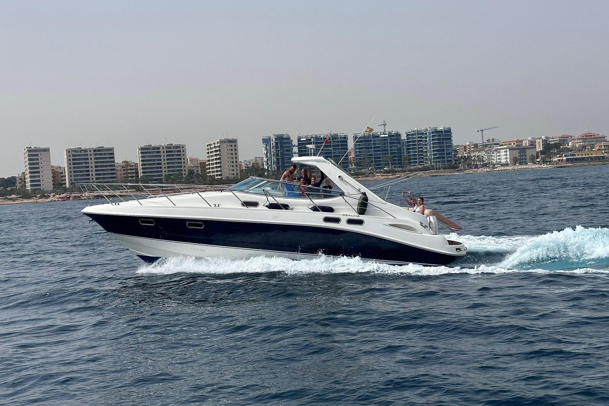 Sealine S42 2007 Sealine S42 yacht cruising on the ocean with city skyline in background.