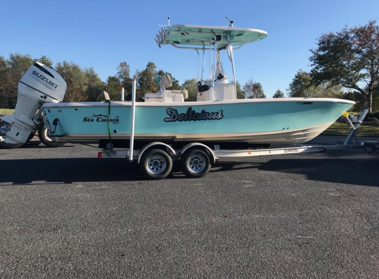 Sea Chaser 26 LX 2018 Sea Chaser 26 LX boat on trailer with Suzuki outboard motor.