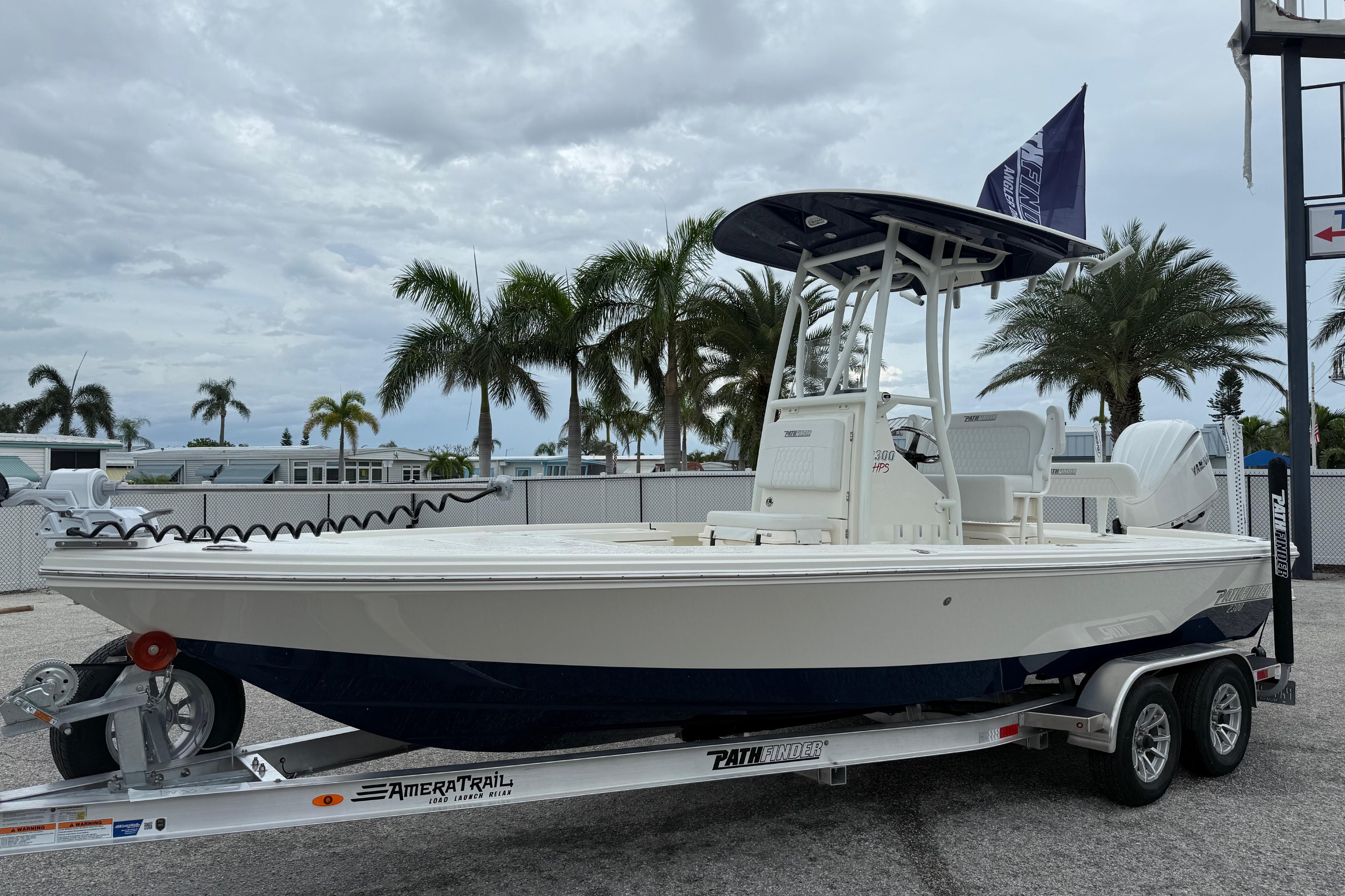 Pathfinder 2300 HPS 2026 Pathfinder 2300 HPS boat on trailer, parked with palm trees in background.