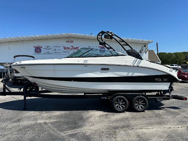 Sea Ray 260 SLX 2023 Sea Ray 260 SLX boat on trailer, parked outdoors, side view.
