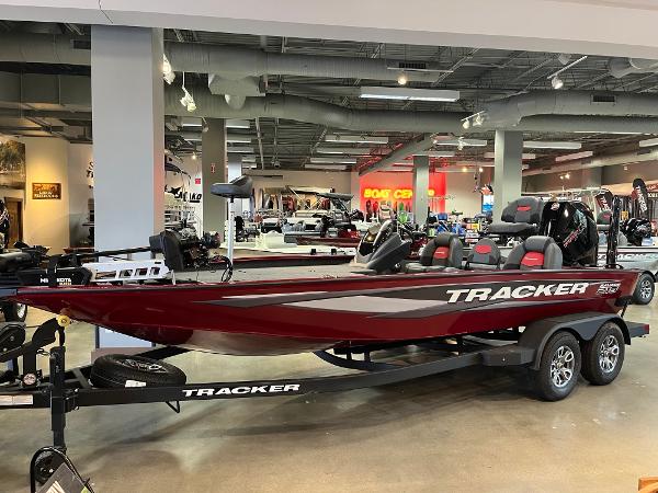 Tracker Savage 215 2025 Tracker Savage 215 boat displayed in a showroom, featuring sleek design and modern amenities.