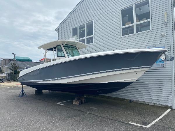 Boston Whaler 350 Outrage 2017 Boston Whaler 350 Outrage boat displayed outdoors near a building.