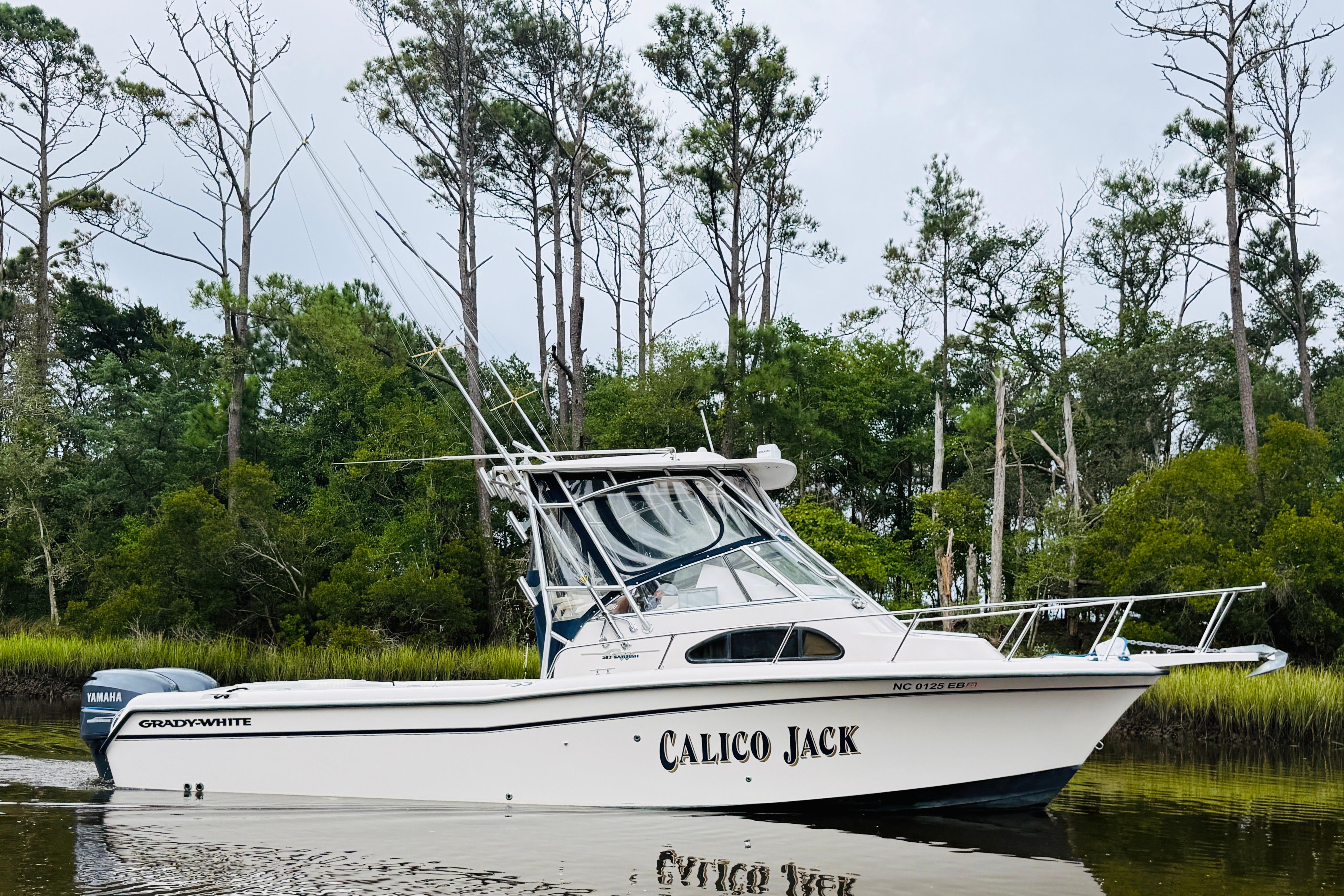 Grady-White Sailfish 282 2003 Grady-White Sailfish 282 boat named "Calico Jack" on a calm river, surrounded by trees.