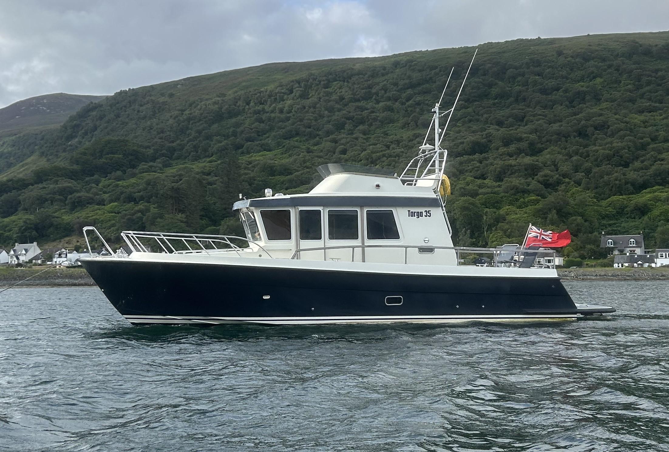 Botnia Targa 35 2015 Botnia Targa 35 boat on water, scenic hillside background.