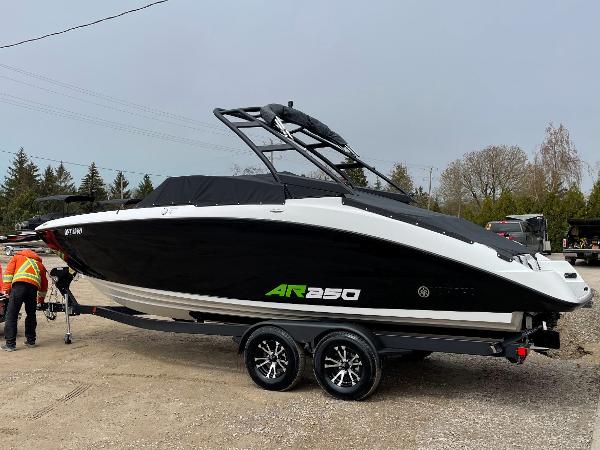 Yamaha Boats 250 2022 Yamaha Boats AR250 on trailer, black and white design, parked outdoors.