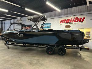 Axis A245 2025 Axis A245 boat in showroom, black and blue design, on trailer.