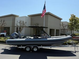 Brig Eagle 8 2025 Brig Eagle 8 boat on trailer, parked outside modern building with American flag.