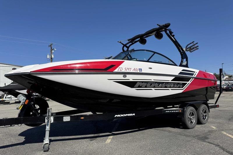 Moomba Mojo 2016 Moomba Mojo boat on trailer, red and white design, parked outdoors.