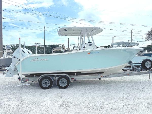 Sea Pro 259 Sport 2022 Sea Pro 259 Sport boat on trailer, light blue hull, parked outdoors.