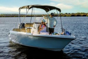 Key West 189 FS Manufacturer Provided Image: 2025 Key West 189 FS boat on water with people relaxing under canopy.