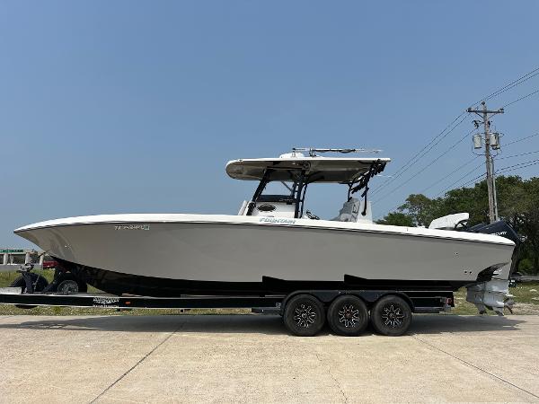 Fountain 34TE 2021 Fountain 34TE boat on trailer, side view, clear sky background.