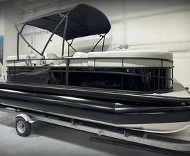 Vision Marine Technologies WX Tritoon 2024 Vision Marine Technologies WX Tritoon boat on trailer in indoor setting.