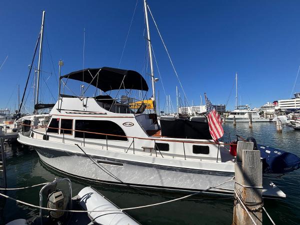 Ocean Yachts Trawler 42 + 2 1979 Ocean Yachts Troller docked at marina under clear blue sky.