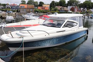 Nimbus W9 T Top X edition 2022 Nimbus W9 T Top X edition boat docked in a scenic marina.