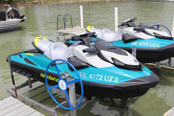 Sea-Doo GTI 170 2024 Sea-Doo GTI 170 jet skis docked on a serene lake.