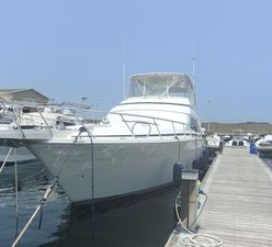 Bertram 630 Convertible 2006 Bertram 630 Convertible yacht docked at marina under clear sky.
