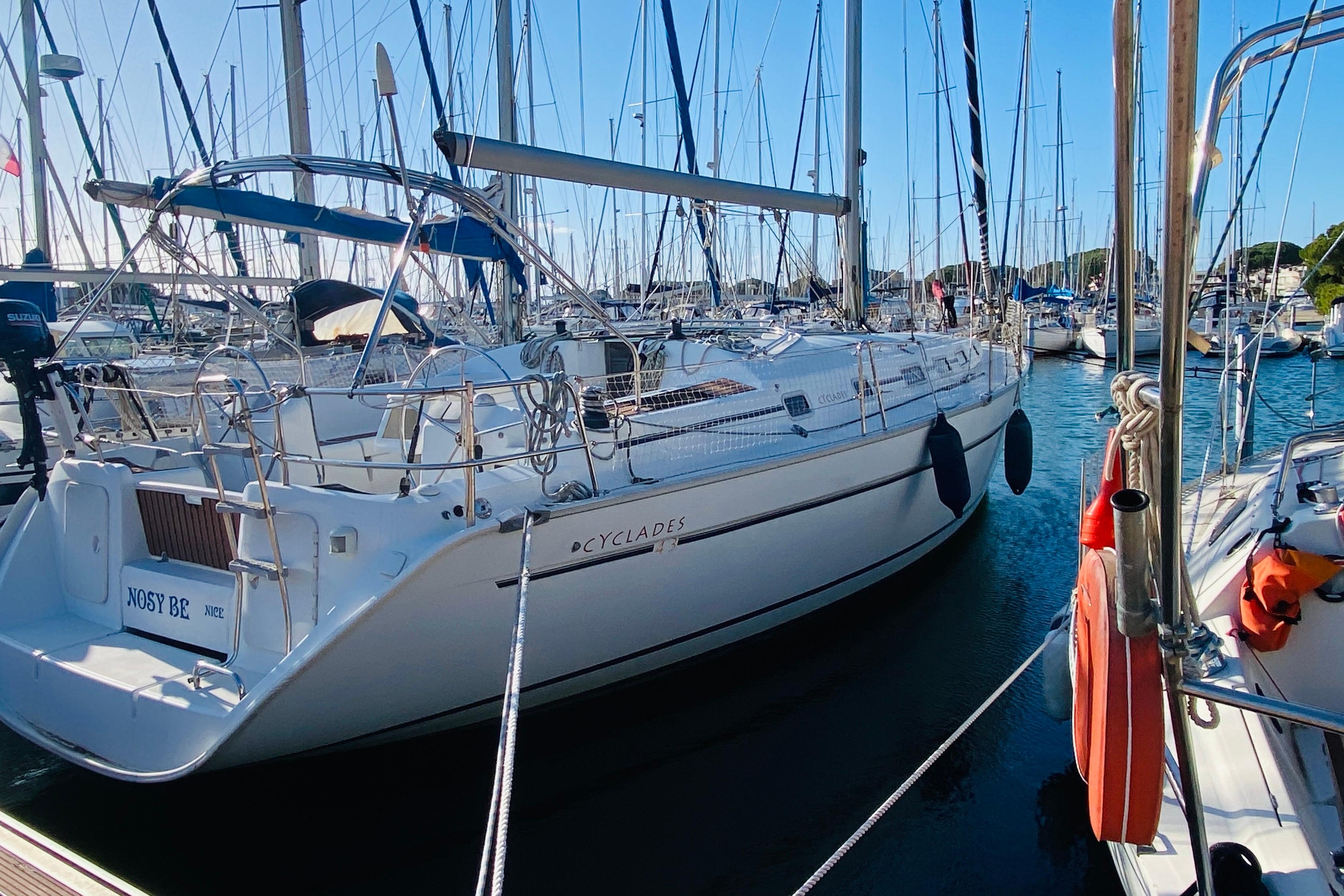 Beneteau Cyclades 43 2005 Beneteau Cyclades 43 sailboat docked in a marina, surrounded by other boats.