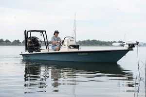 Maverick 18 HPX-V 2023 Maverick 18 HPX-V boat on calm water with a person steering.