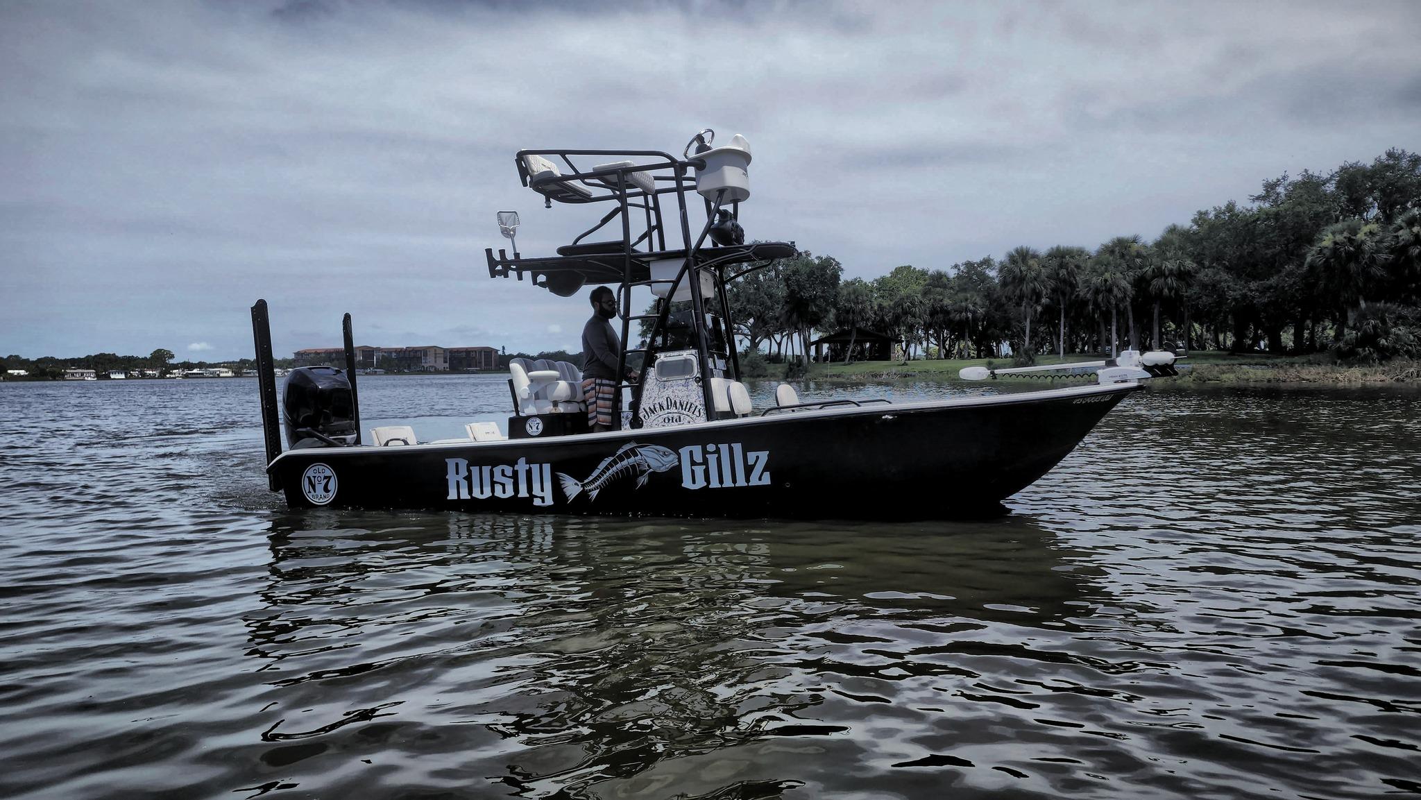 Action Craft 24 ACE 2017 Action Craft 24 ACE boat on water, labeled "Rusty Gillz," with trees in the background.