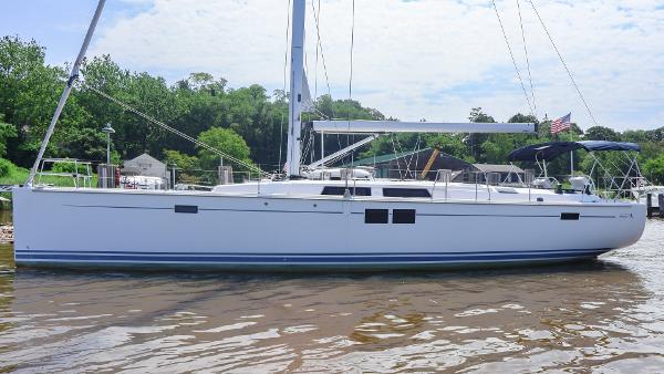 Hanse 505 2018 Hanse 505 sailboat docked on a calm river, surrounded by greenery.
