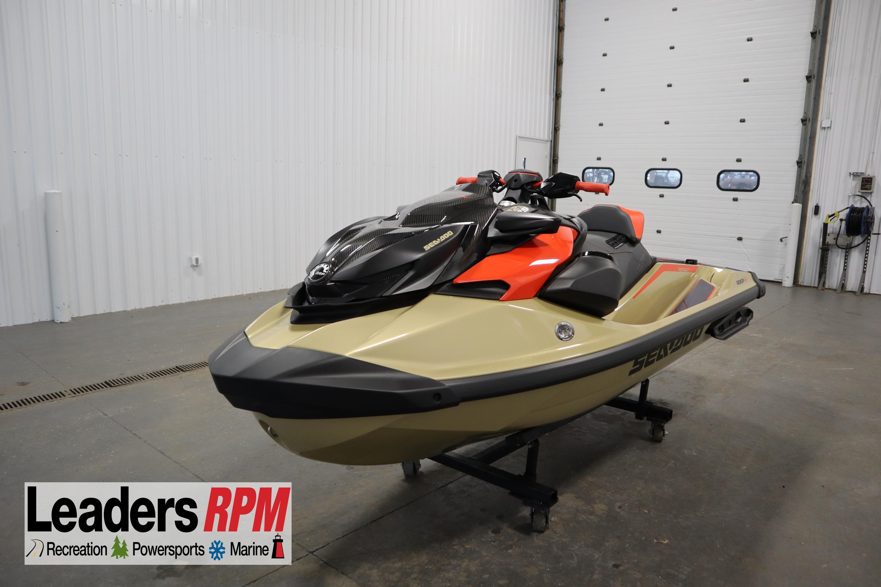 Sea-Doo RXP-X™ 325 iBR Metallic Tan / Lava Red Premium 2025 Sea-Doo RXP-X™ 325 iBR in Metallic Tan and Lava Red, displayed indoors.