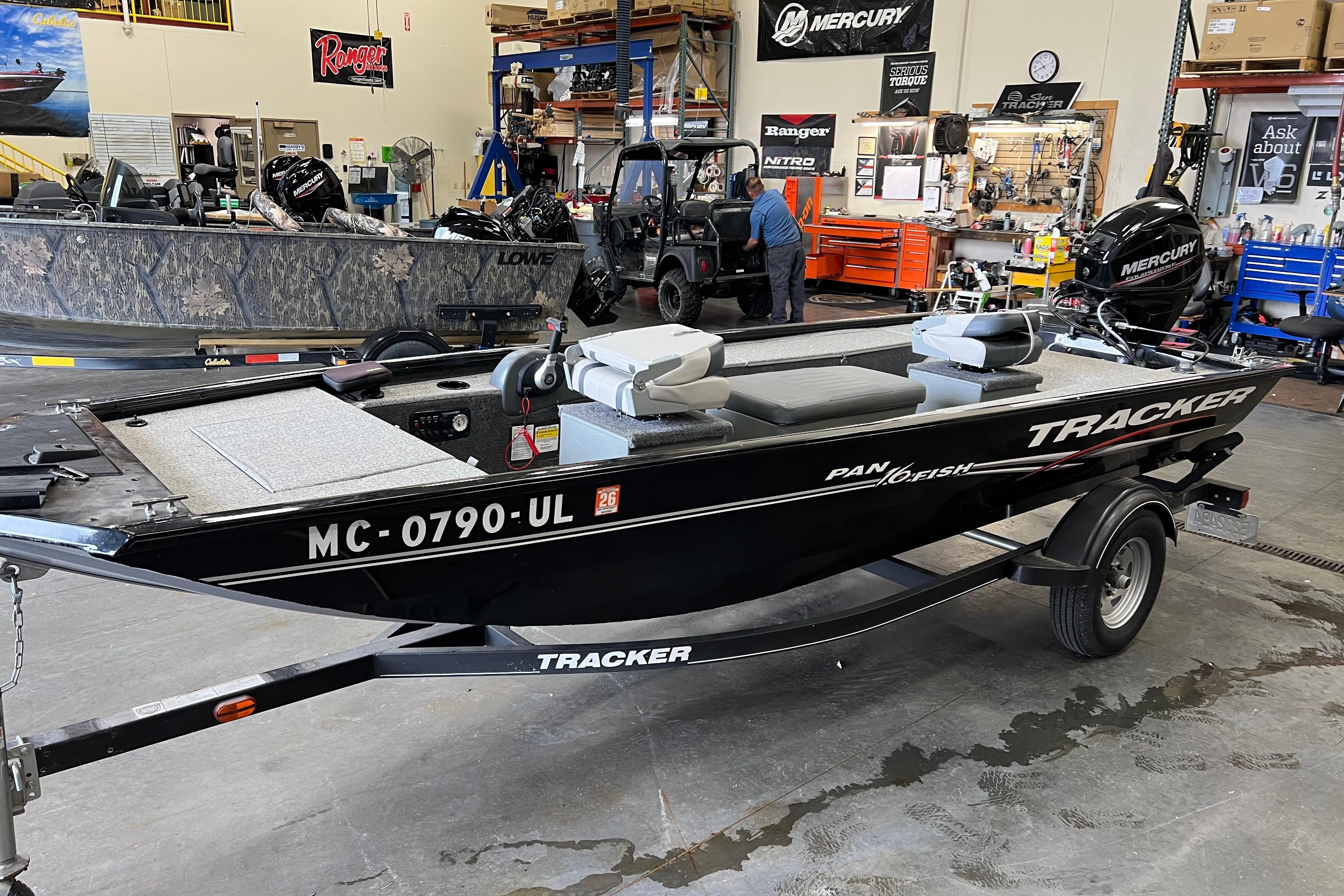 Tracker Panfish 16 2020 Tracker Panfish 16 boat in a workshop, featuring a Mercury engine.