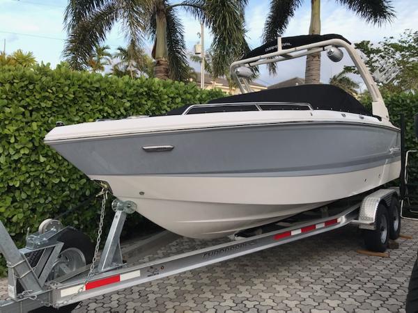 Chaparral 247 SSX 2025 Chaparral 247 SSX boat on trailer, surrounded by lush greenery and palm trees.