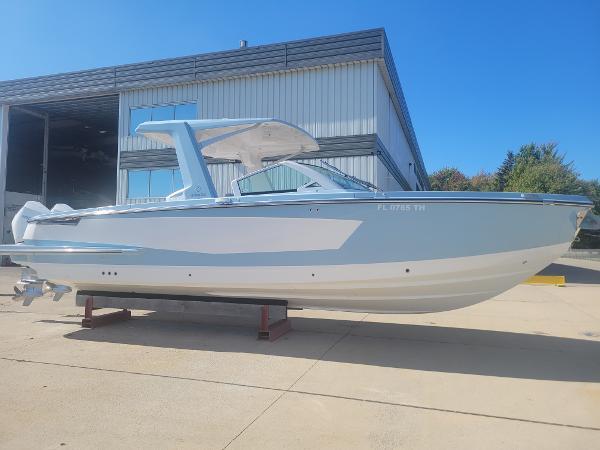 Aviara AV32 OB 2022 Aviara AV32 OB boat displayed outdoors near a warehouse.