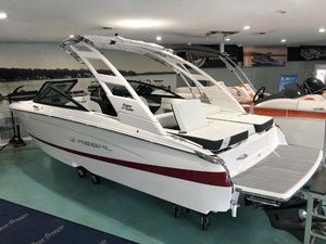 Regal LS2 2024 Regal LS2 boat in showroom, white with red stripe, sleek design, modern features.