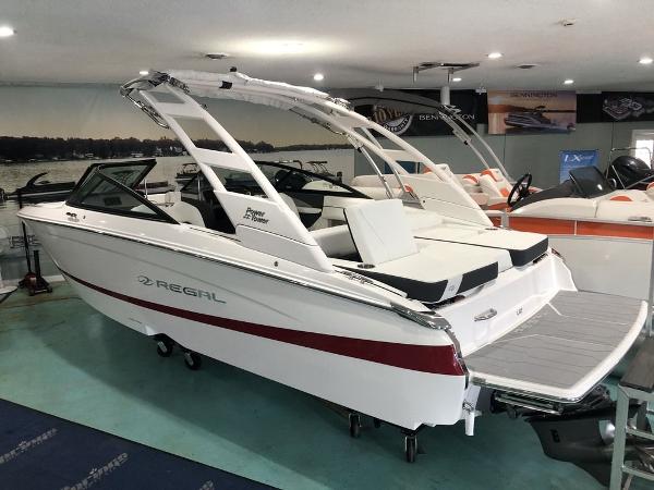 Regal LS2 2024 Regal LS2 boat in showroom, white with red stripe, sleek design, modern features.