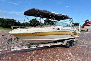 Sea Ray 270 Sundeck 2004 Sea Ray 270 Sundeck boat on trailer, parked on brick pavement.
