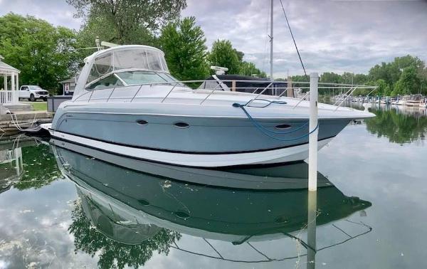 Formula 40 Cruiser 2005 Formula 40 Cruiser yacht docked on calm water, surrounded by lush greenery.