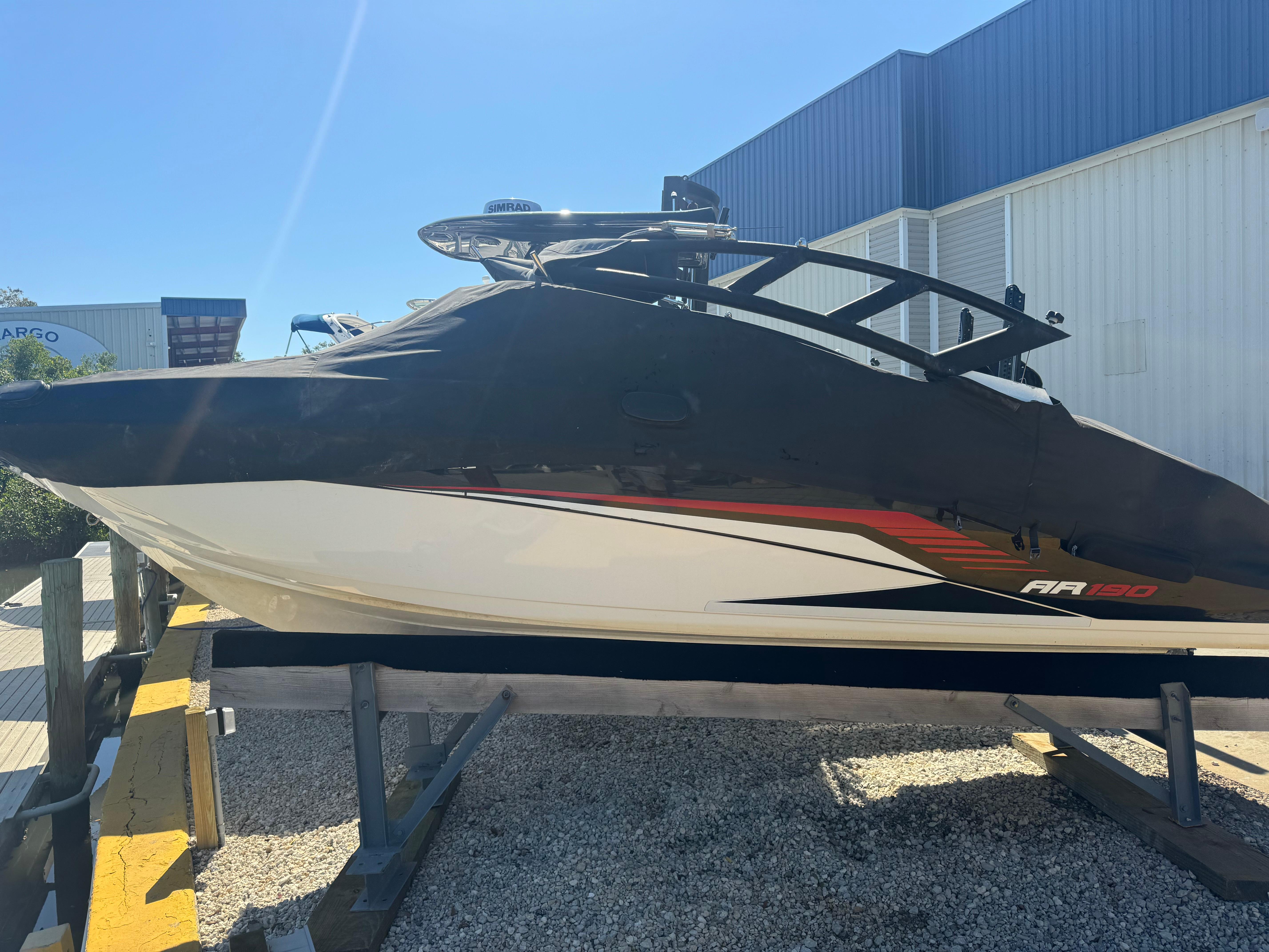 Yamaha Boats AR190 2018 Yamaha AR190 boat on a trailer, covered, in a sunny outdoor setting.