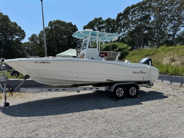 NauticStar 251 Hybrid 2019 NauticStar 251 Hybrid boat on trailer, parked outdoors.