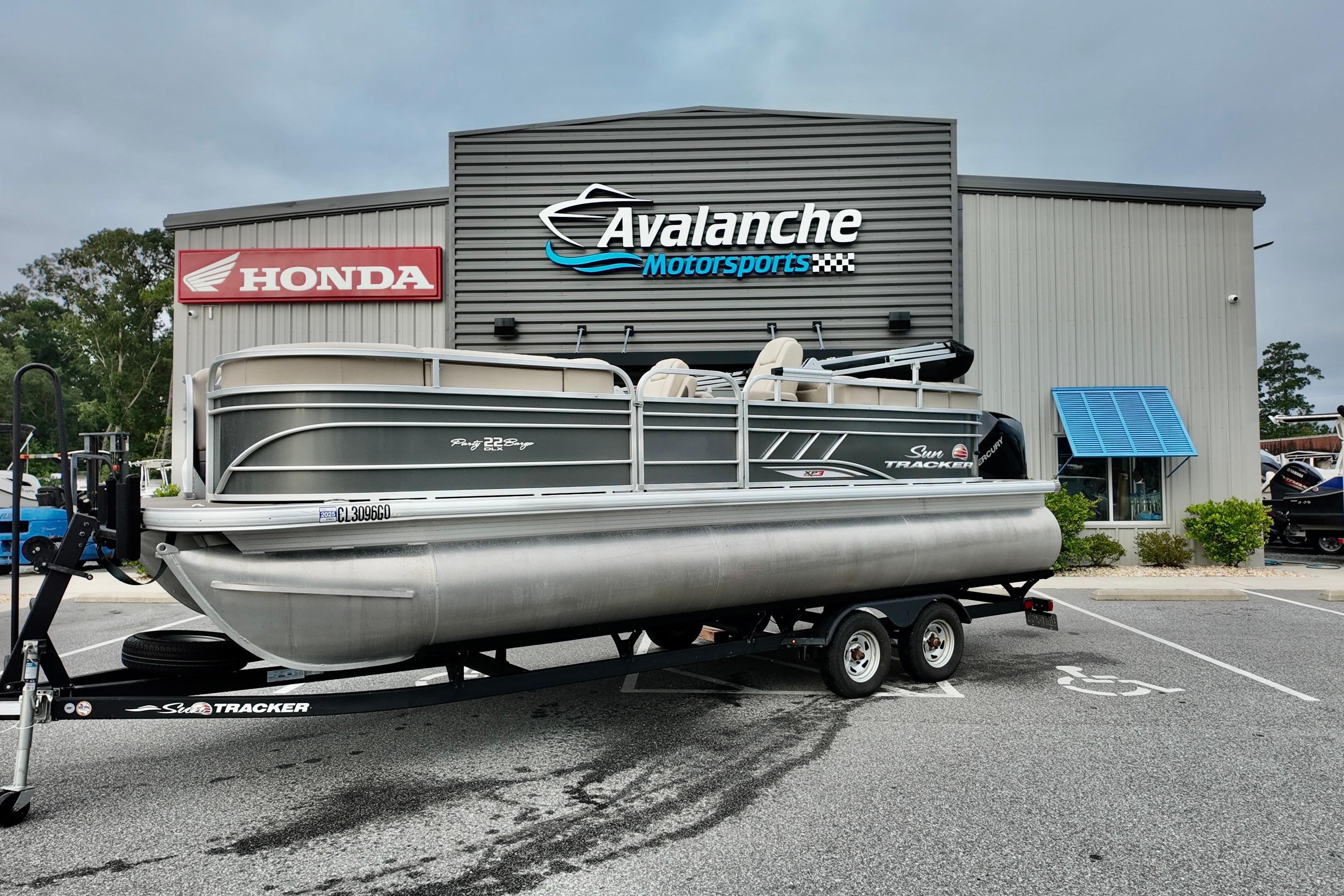 Sun Tracker Party Barge 22 DLX 2023 Sun Tracker Party Barge 22 DLX pontoon boat on trailer at Avalanche Motorsports.