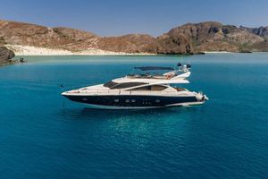 Sunseeker 75 Yacht Sunseeker 75 Yacht 2005 anchored in clear blue waters near a rocky coastline.