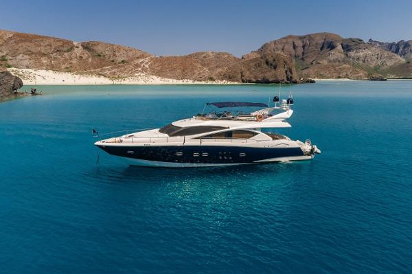Sunseeker 75 Yacht Sunseeker 75 Yacht 2005 anchored in clear blue waters near a rocky coastline.