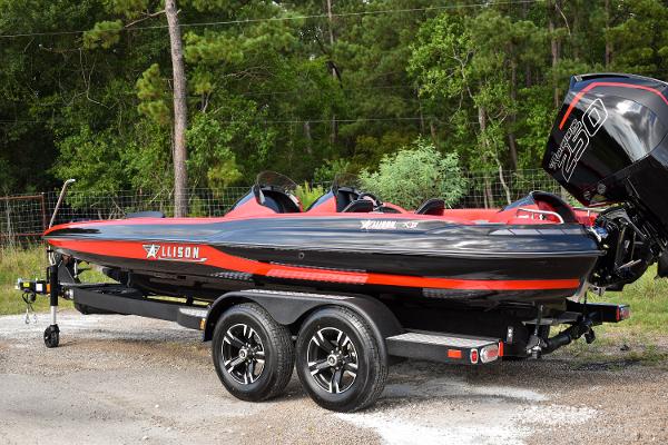 Allison XB-21 Allison XB-21 2023 model boat on a trailer, black and red design, parked outdoors.