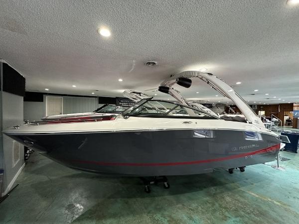 Regal LS4 Ultimate 2024 Regal LS4 Ultimate boat in showroom, sleek design, gray and white exterior.